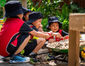 CIS Magical Garden Party - students with sand